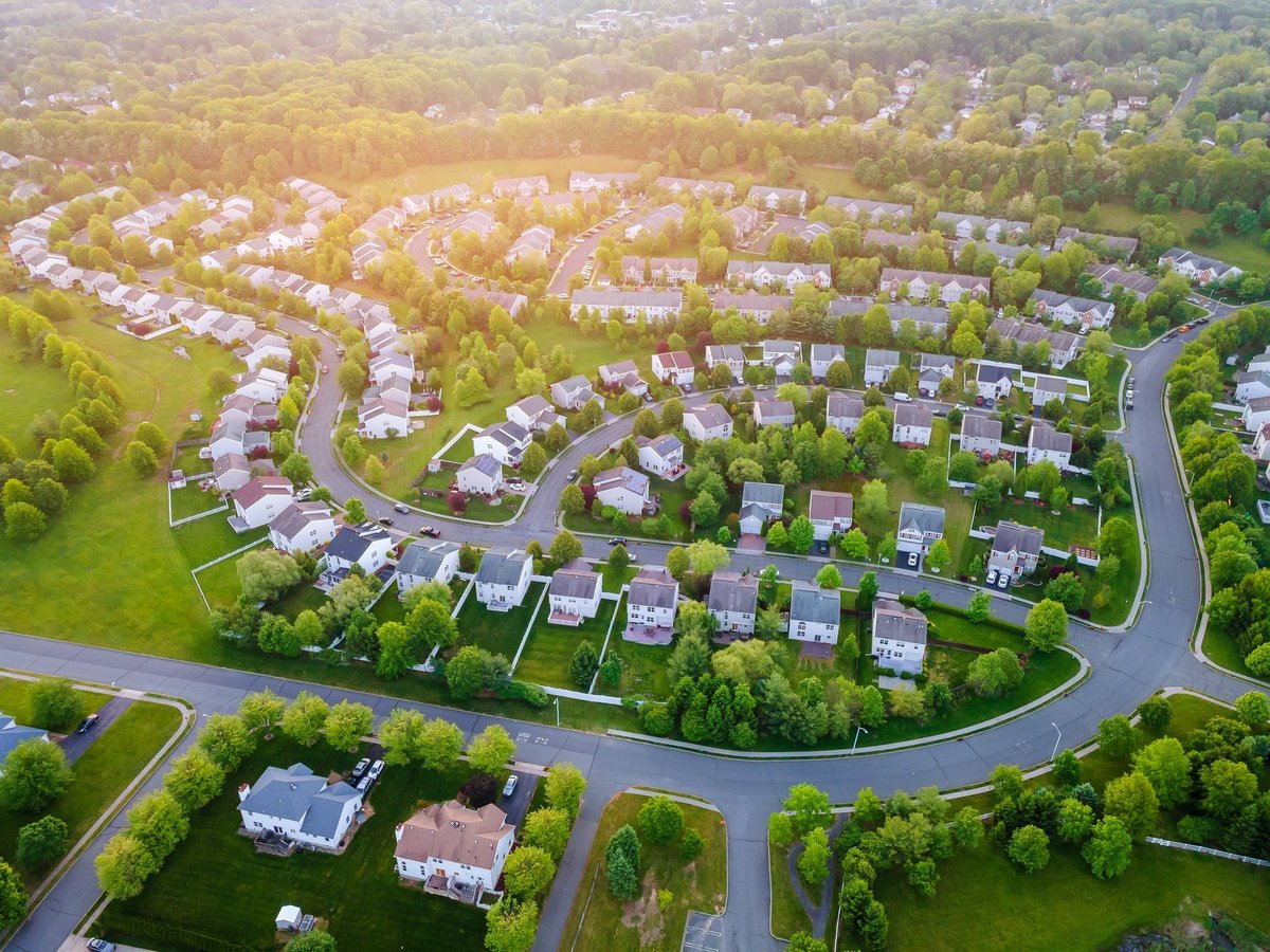 Aerial panorama view of suburban residential neighborhood with tree-lined streets