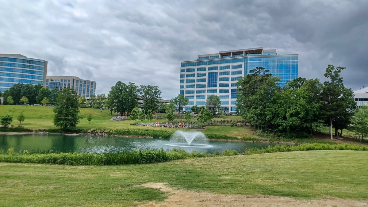 Modern office buildings in corporate park with green lawns and walking paths